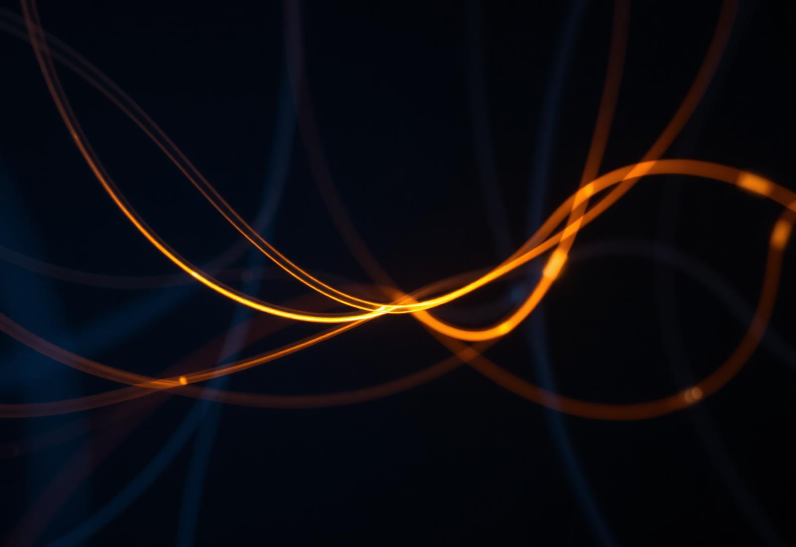 Abstract fibre-optic light strands representing interconnected systems